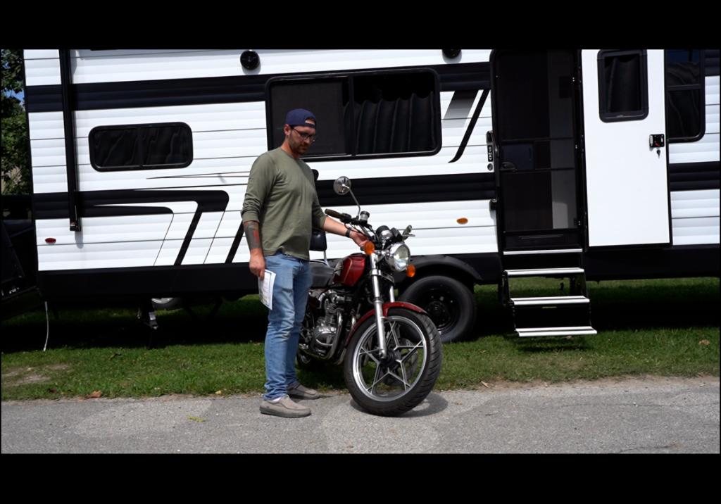 Motorcycle with rv behind it
