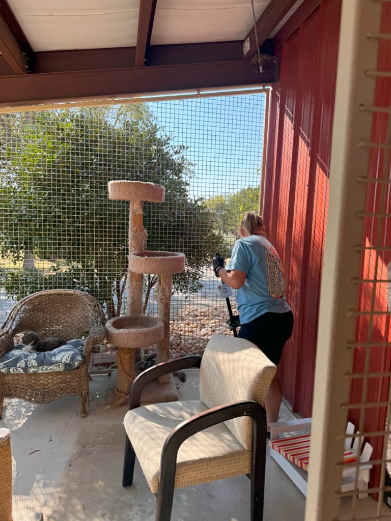 Grand Design owner sweeping "catio". 