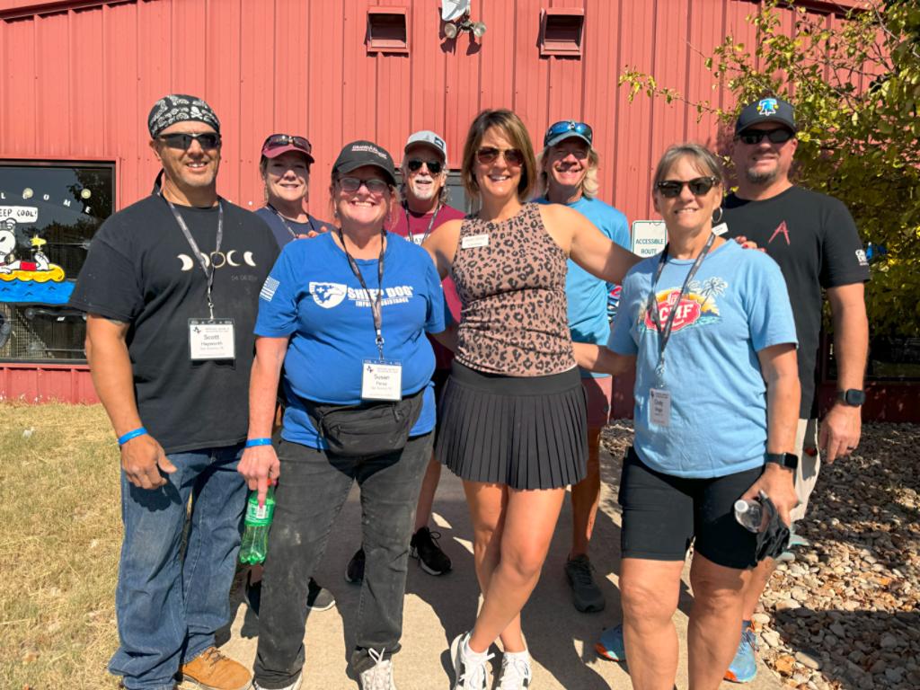 Impact team members posing for a group picture before an event