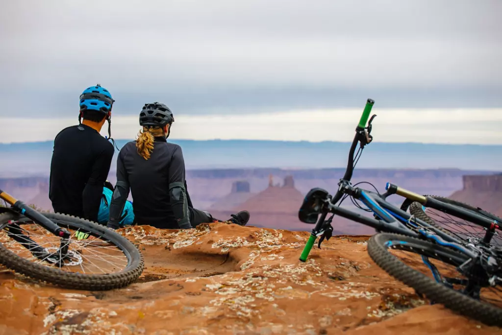 Biking couple watching the sunset in Utah.