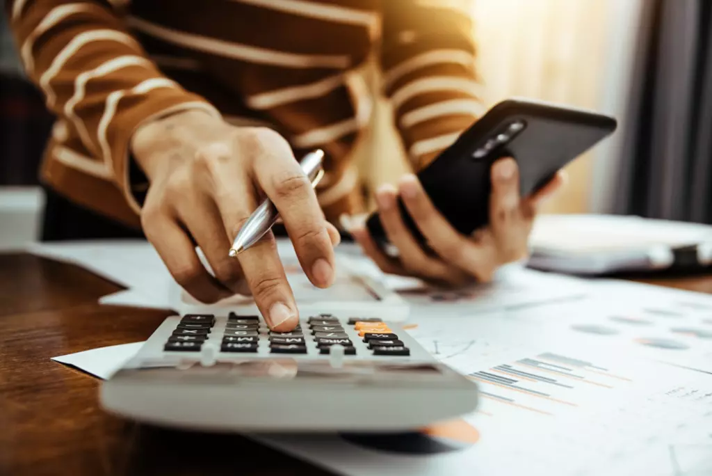 Female accountant or banker making calculation of finance and economy banking concept.