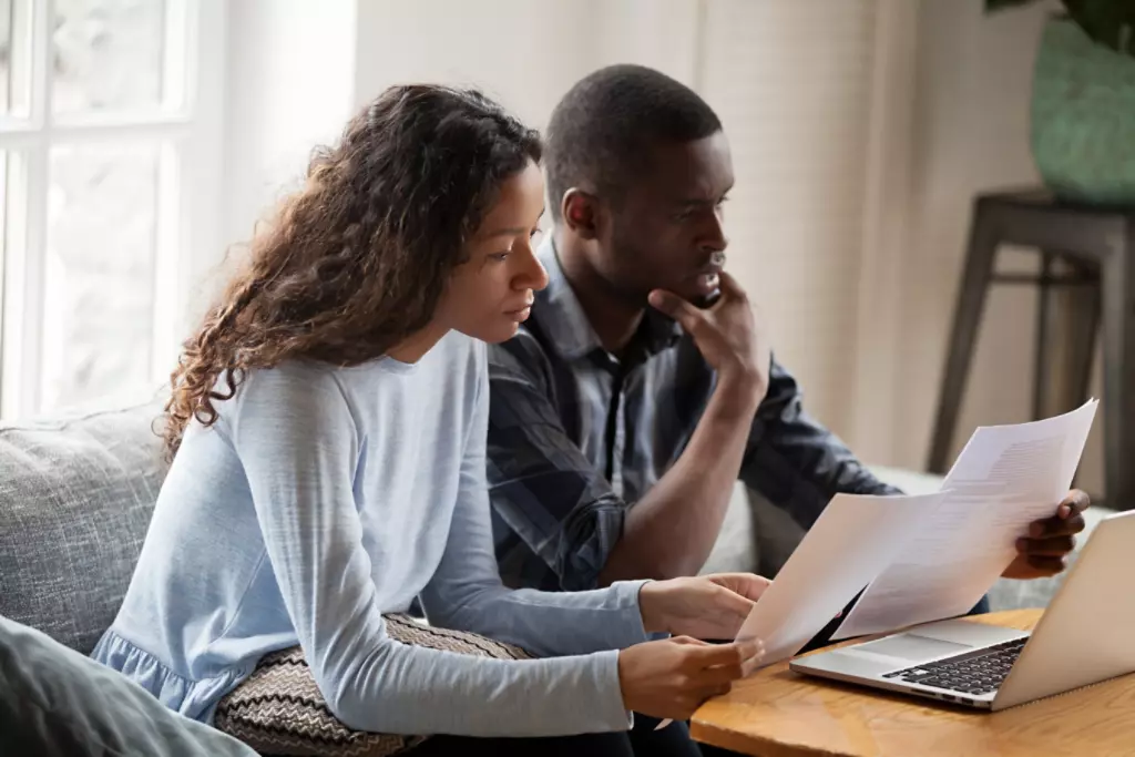 Couple reviewing papers or bills together. 