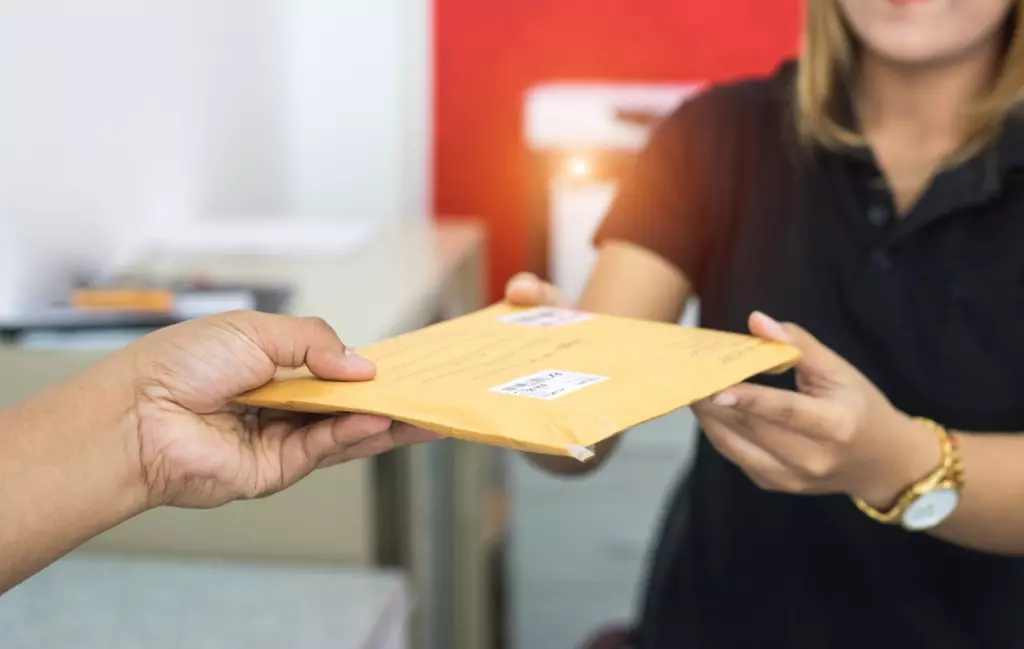 Woman receiving letter from man.