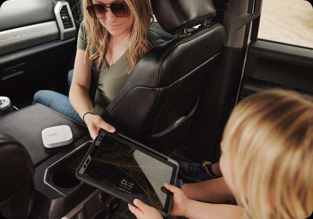 Woman sharing device with child. 