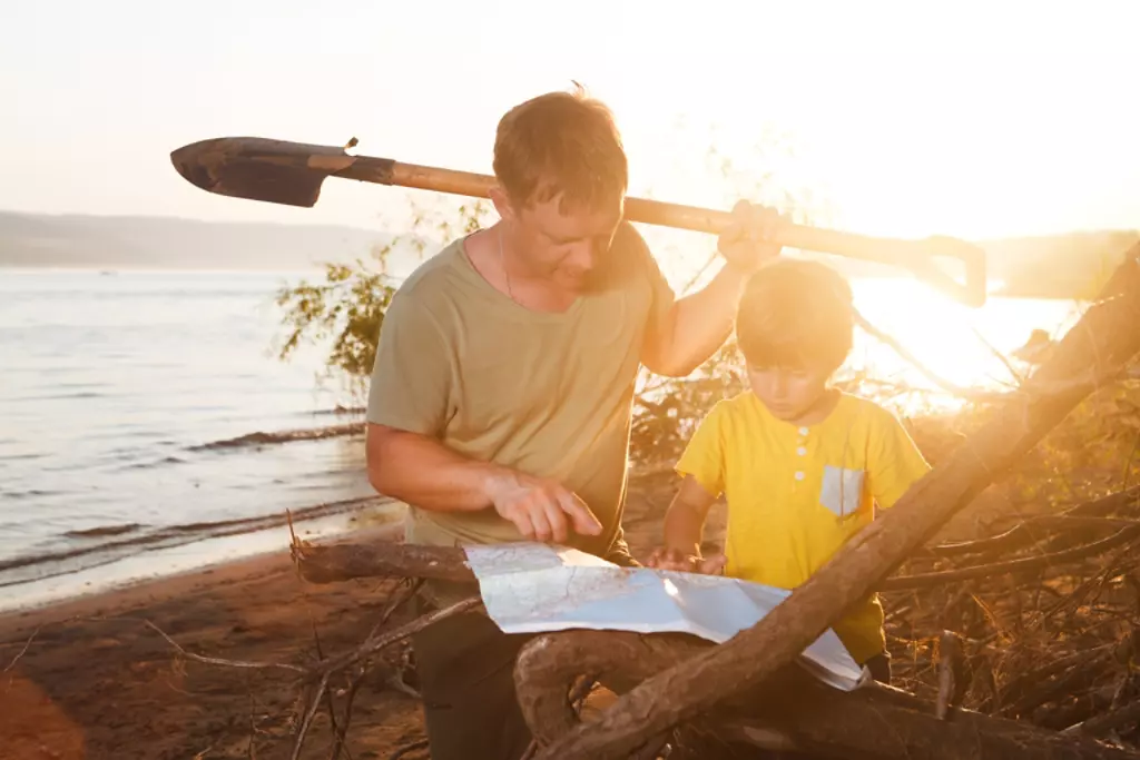 father and son looking at map to go on scavenger hunt