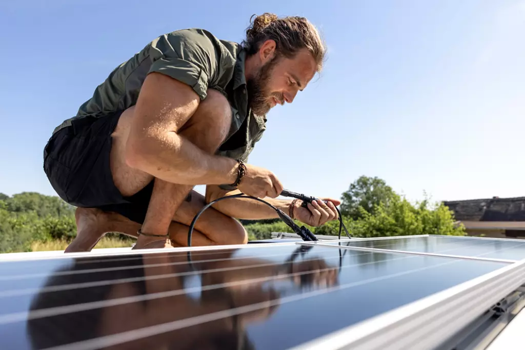 Solar panel being installed by a man. 